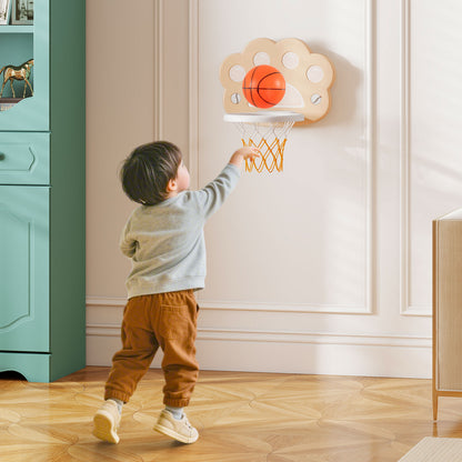 A young boy plays basketball on the adjustable hoop with soccer goal indoors