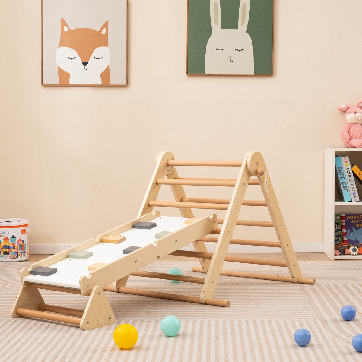 The natural wood climbing frame is set up in a child's playroom with toys scattered around