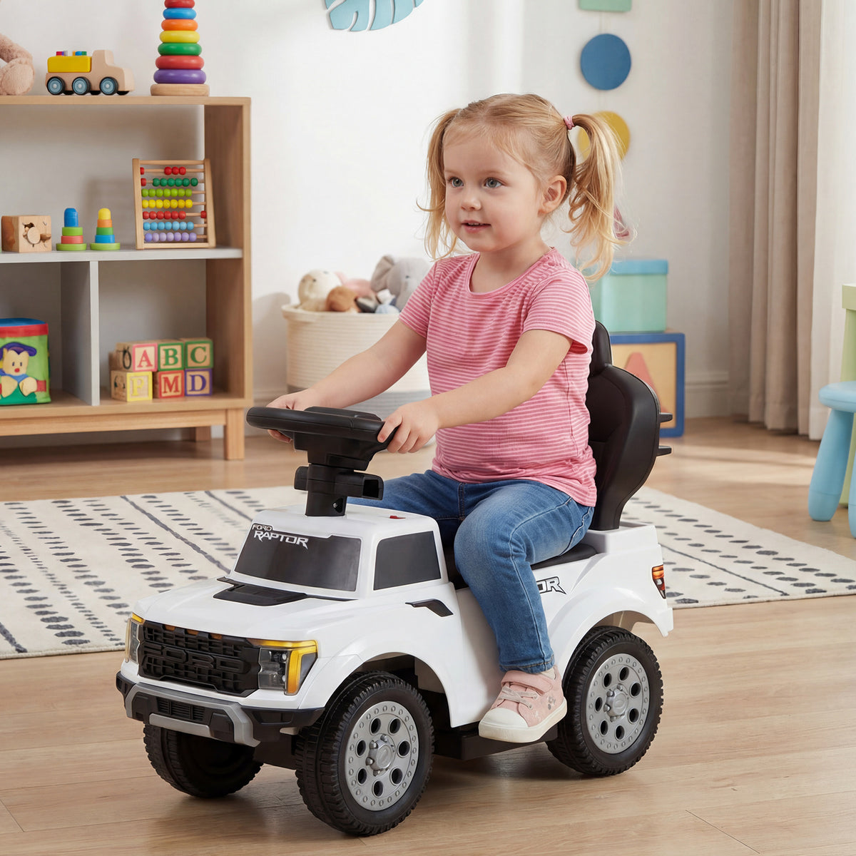 Toddler girl riding the white push car indoors
