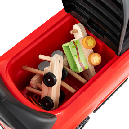 Storage compartment of the red ride on toy car filled with wooden toys
