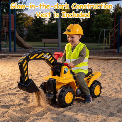 A young boy digging sand with the ride on excavator bulldozer in a playground