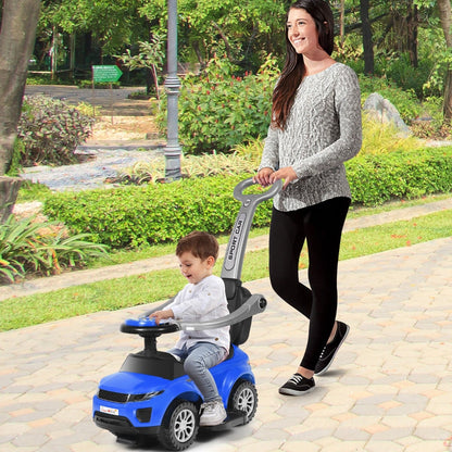 Woman pushing a child on a blue ride on push car stroller in a park