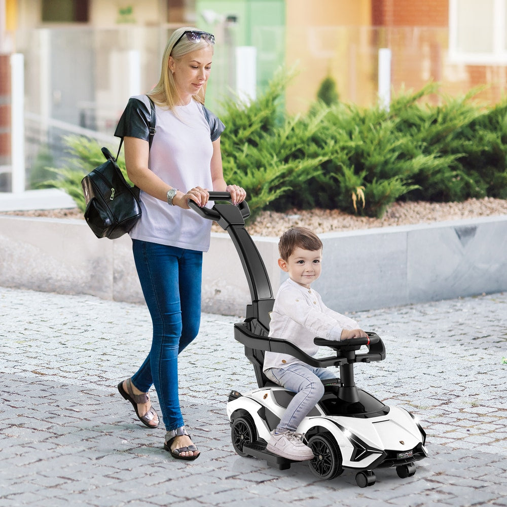 A woman pushes a child in the white 3-in-1 ride on push car outdoors