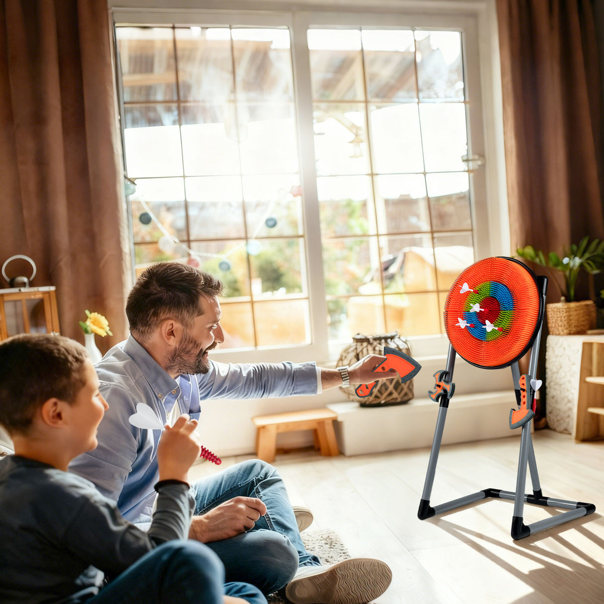 Father and son enjoying the throwing target set indoors