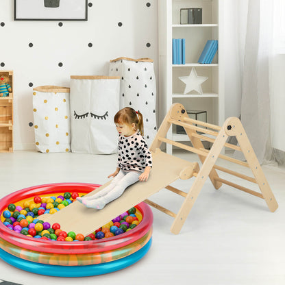 Toddler sliding down the ramp of the climbing frame into a ball pit