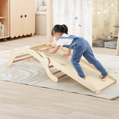 A young child climbs the wooden slide ramp of the toddler climber