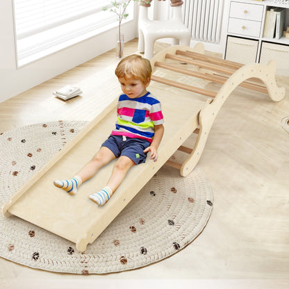 A young boy slides down the wooden climbing arch indoors