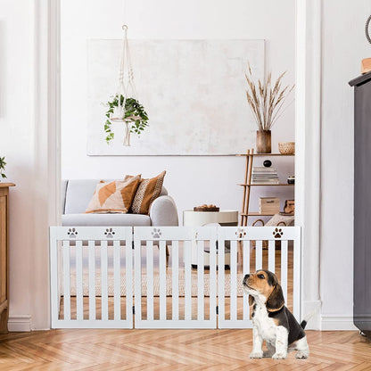 A white folding pet gate is placed in a living room doorway with a beagle puppy nearby