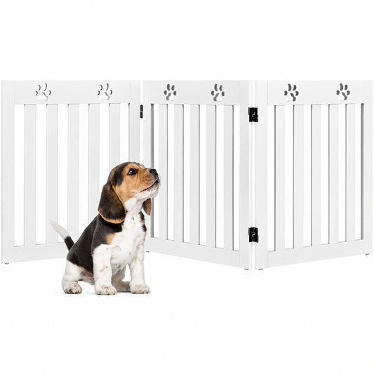 Dog standing behind a white pet gate with paw prints on a white background