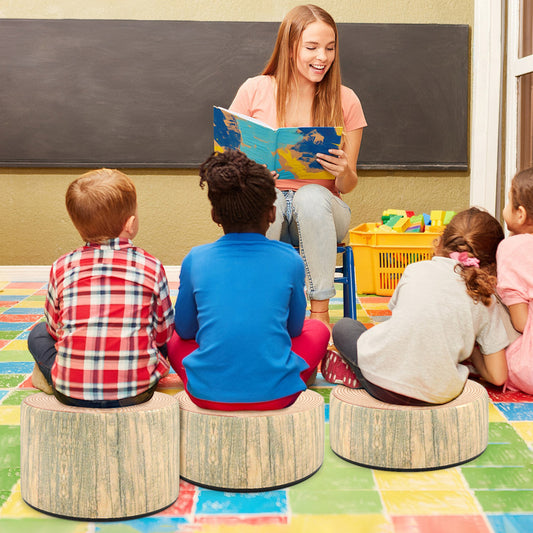 The kids seating being used by children sitting on the floor in a classroom while reading