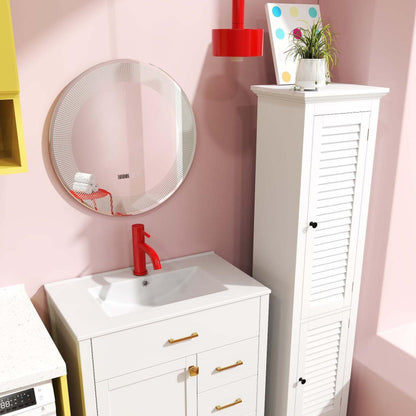 The bathroom vanity with a red tap and a tall floor cabinet next to a round mirror