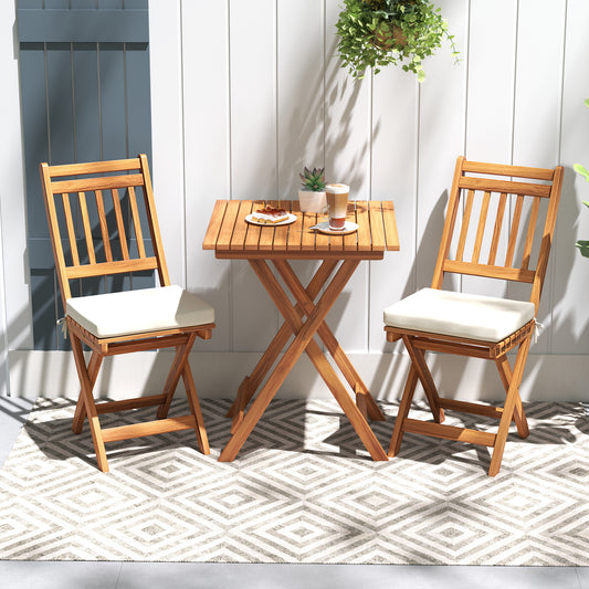 This outdoor bistro set shows two acacia wood chairs with cream cushions and a folding table
