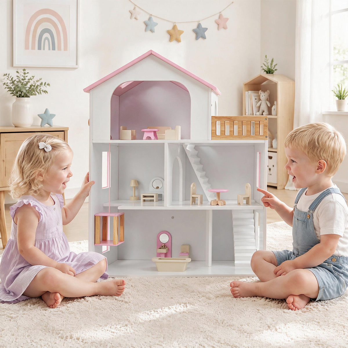 Two young children sitting on the floor and playing with the pink wooden dollhouse