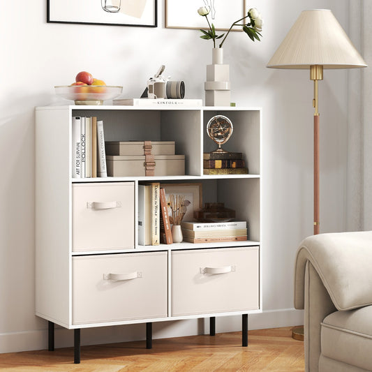 The white bookcase with drawers is shown in a living room setting with books and decorative items