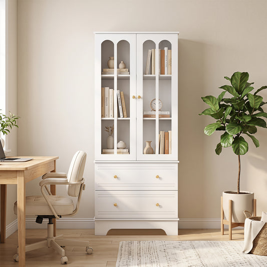 The white display storage cabinet filled with books and decorative items in a home office setting