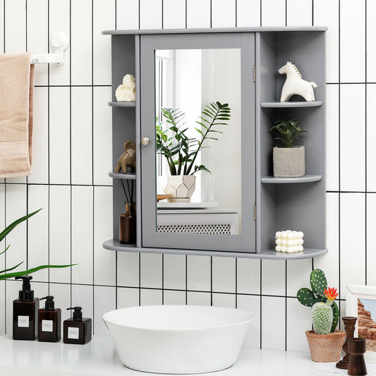 Grey mirrored wall cabinet in a bathroom above a sink, showing it in use with toiletries and plants