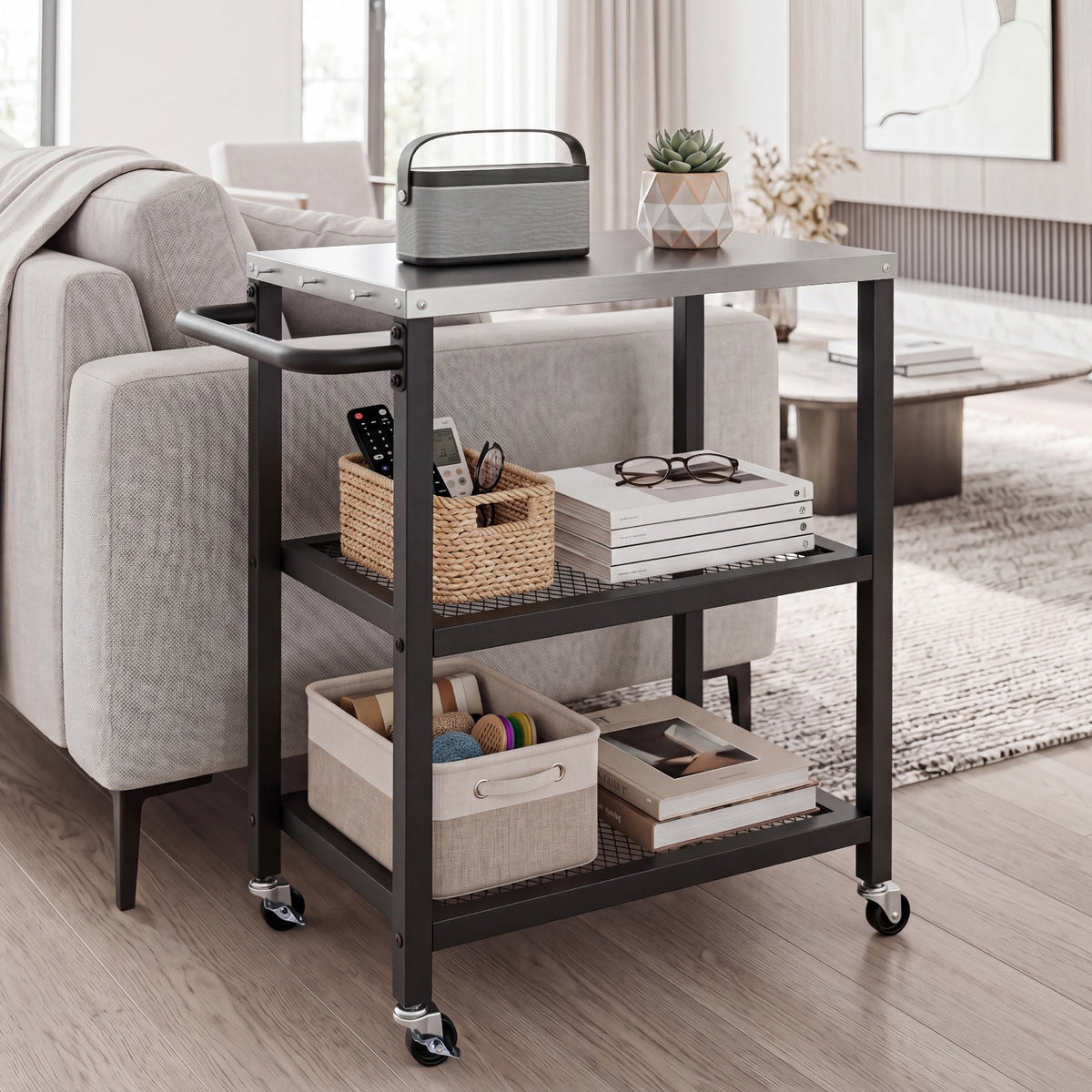The rolling kitchen cart with a stainless steel top, holding books and a basket