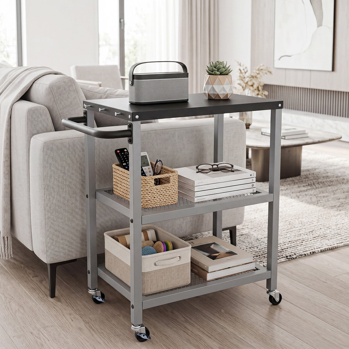 The rolling kitchen cart is displayed in a living room setting with books and a speaker on it