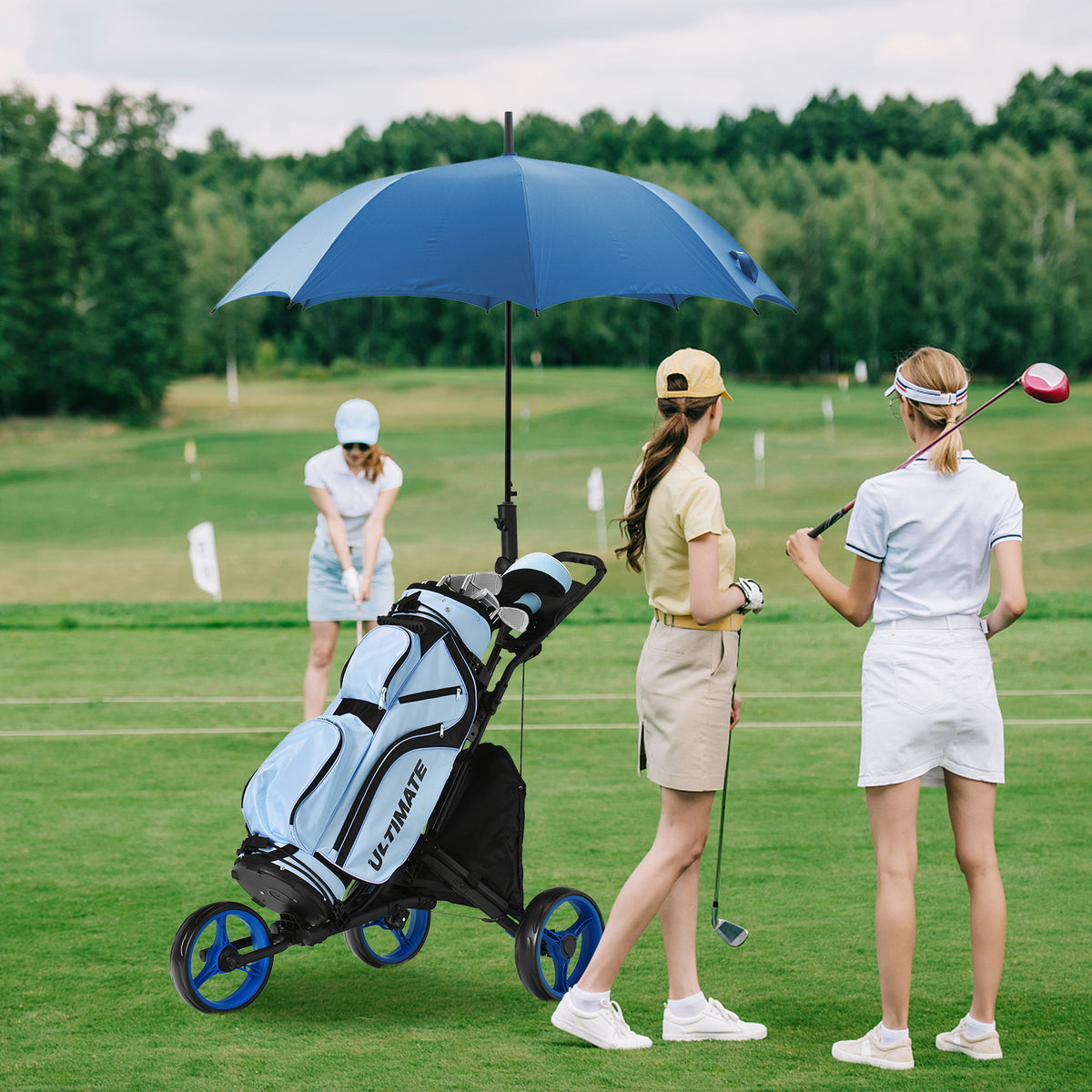 The golf trolley with a blue umbrella and bag on a green course with players