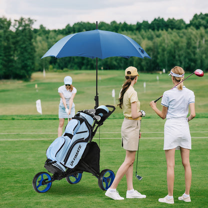 The golf trolley with a blue umbrella and bag on a green course with players