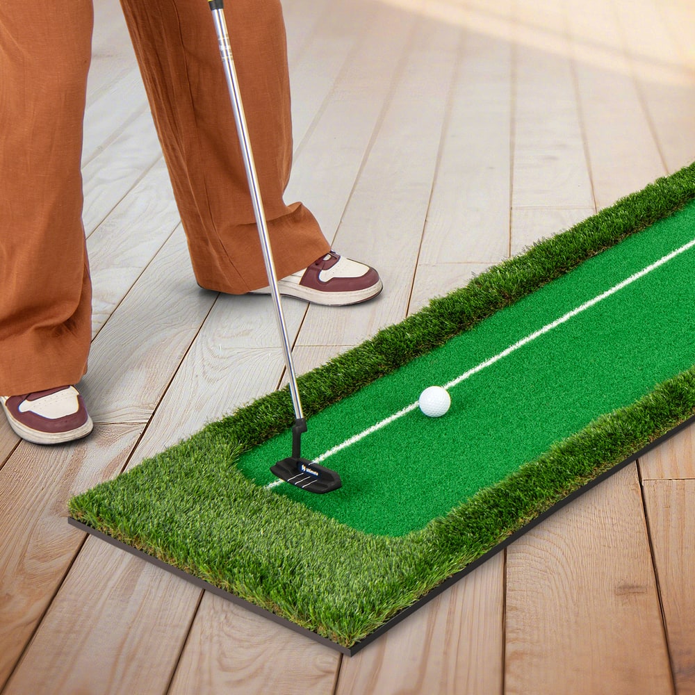 A person is putting on the golf practice mat indoors on a wooden floor