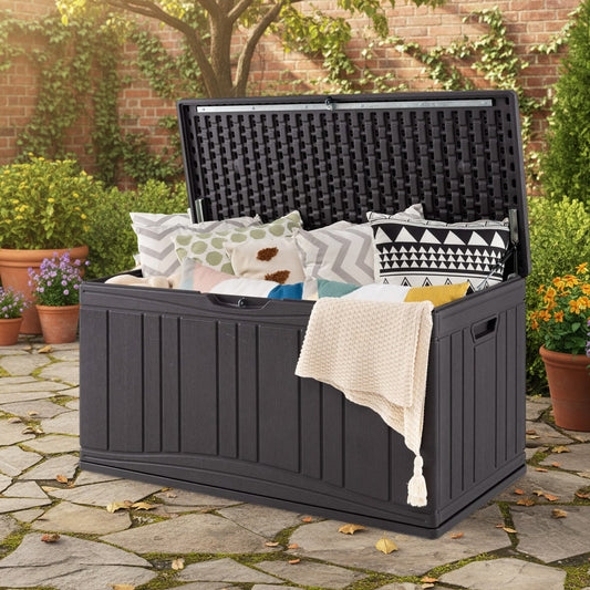 the patio storage container is open and filled with cushions and blankets