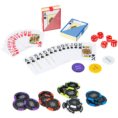 Poker chips, cards and dice laid out on a green surface