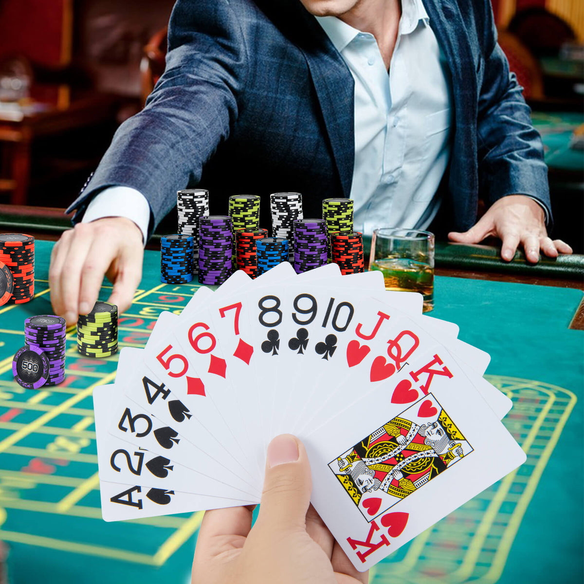 Poker chips and cards being used at a casino table