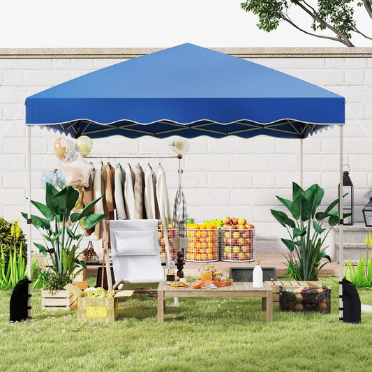 The pop up tent set up in a garden with clothes racks and a picnic table underneath