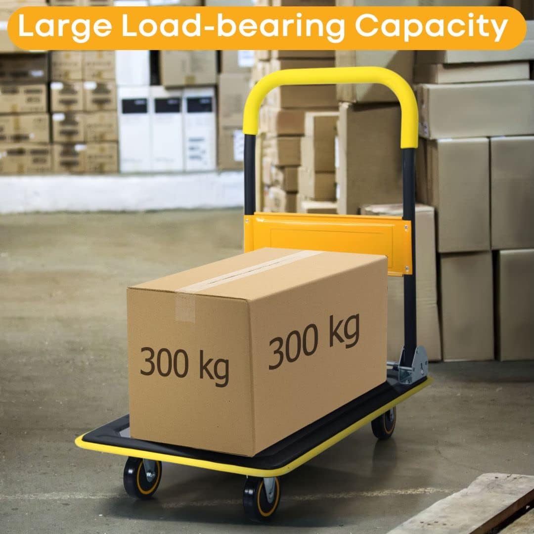 The push cart carrying a large cardboard box inside a warehouse with stacked storage boxes