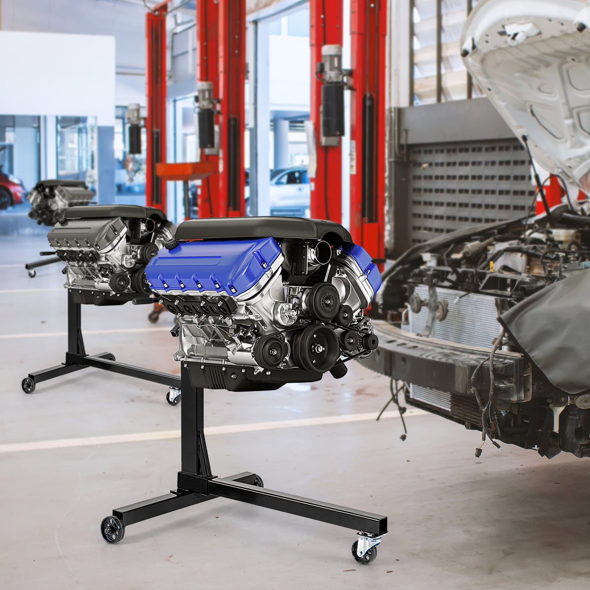 Two engine stands each holding a car engine in a workshop