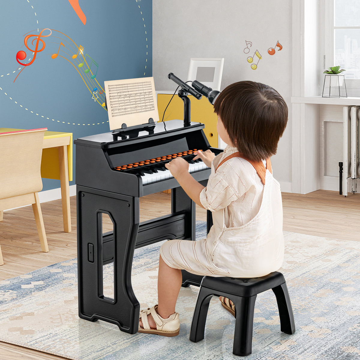 A child plays the electronic piano keyboard with adjustable microphone, sitting on the stool