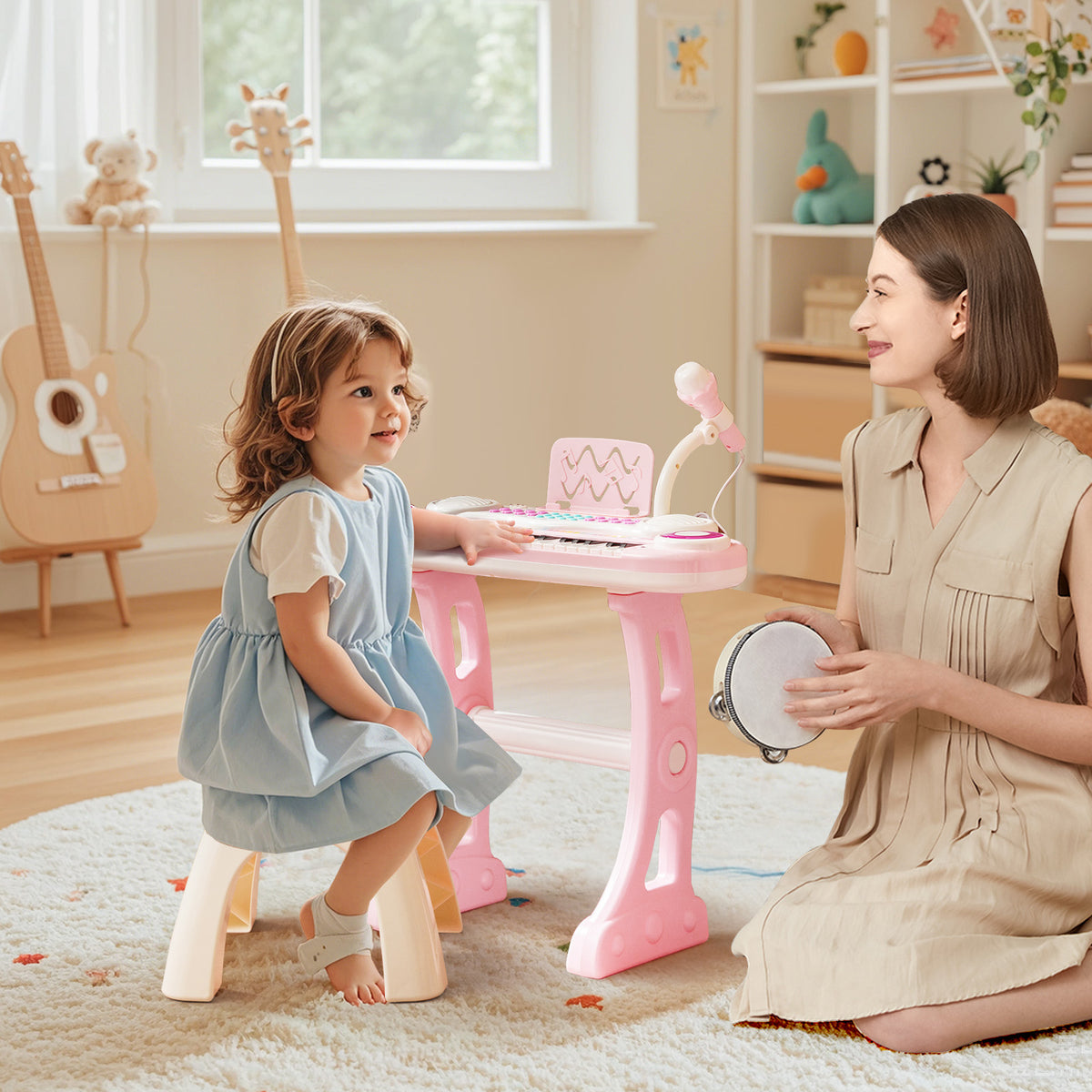A woman and a child playing with the pink electronic piano in a room