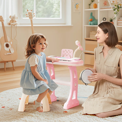 A woman and a child playing with the pink electronic piano in a room