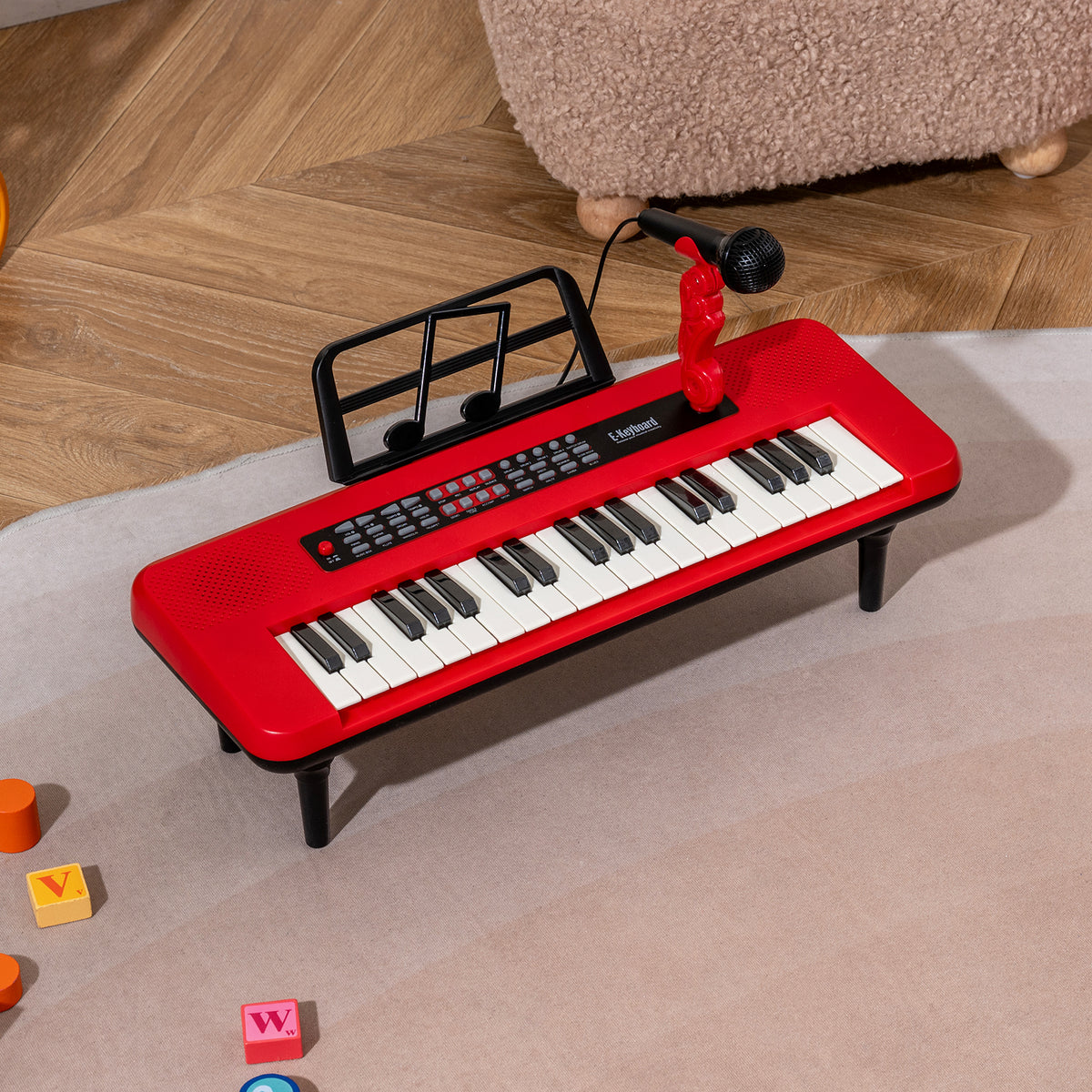 The red kids piano keyboard placed on a soft rug in a playroom setting