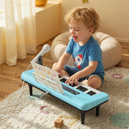 A young boy playing the blue portable piano keyboard with microphone