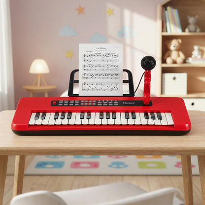 The kids piano keyboard sitting on a wooden table with sheet music attached