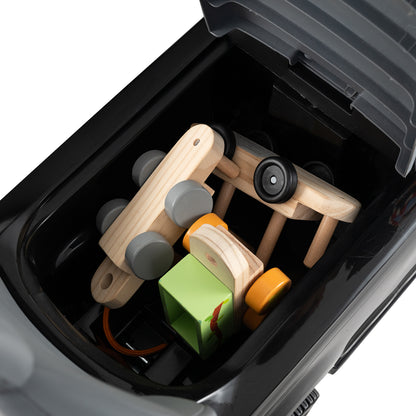 Storage compartment of the black push and pedal ride on toy with wooden toys inside