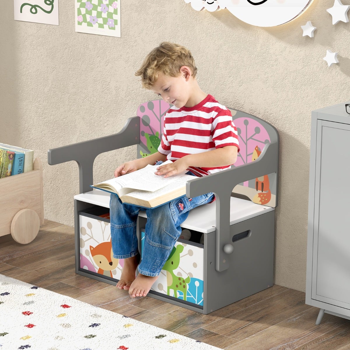 A young boy reads a book while sitting on the kids activity bench