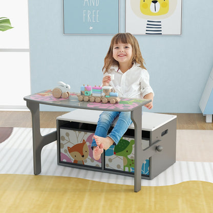 A young girl plays with a toy train while sitting at the kids activity bench as a table