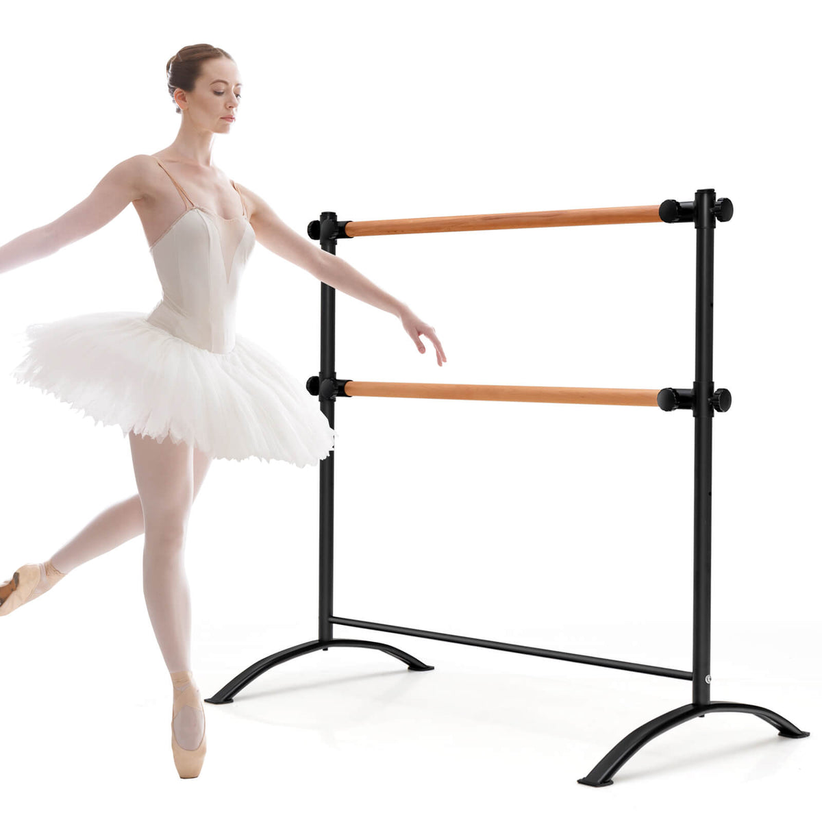 A ballet barre with two wooden bars and black metal frame, used by a dancer