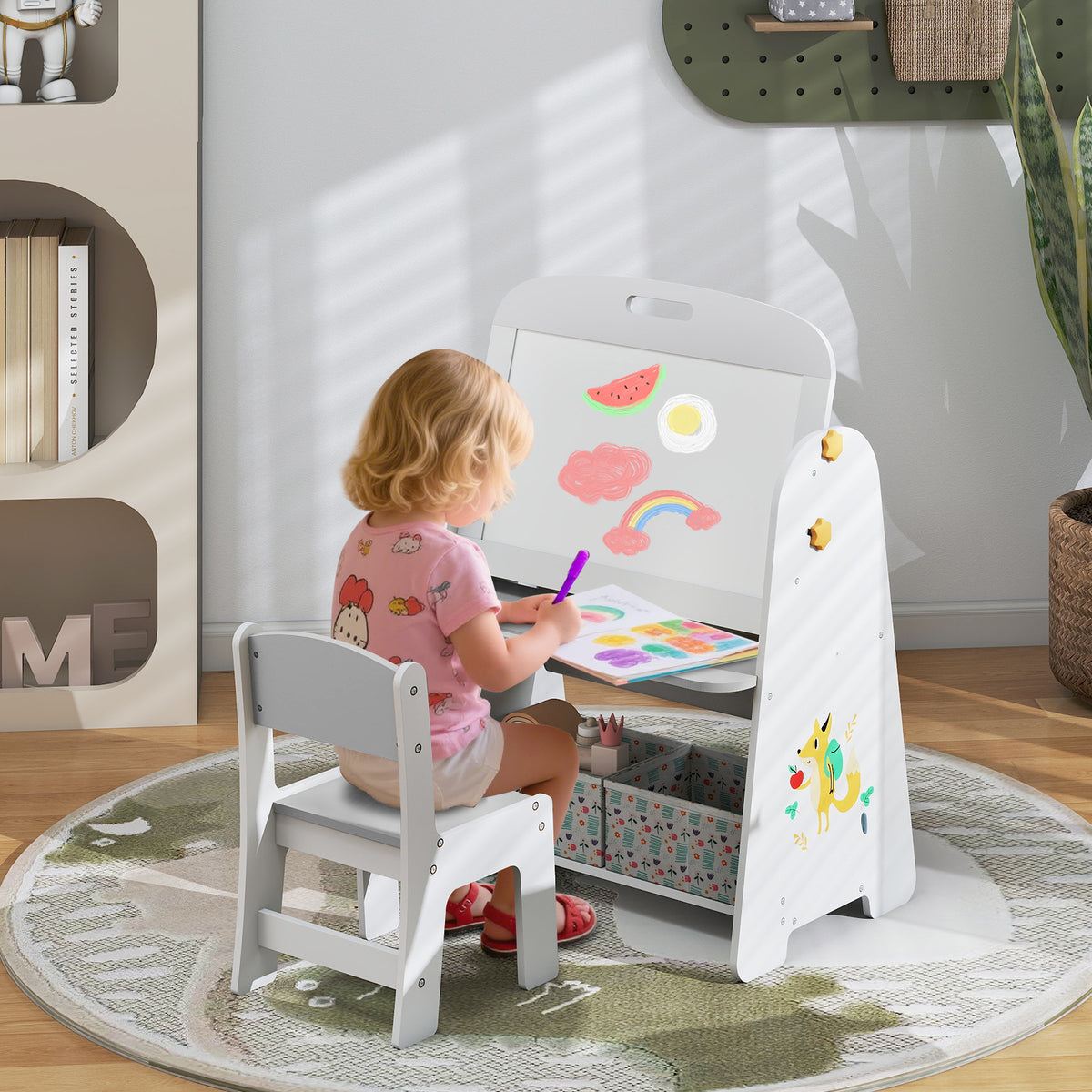 A young child sits at the art easel drawing on paper
