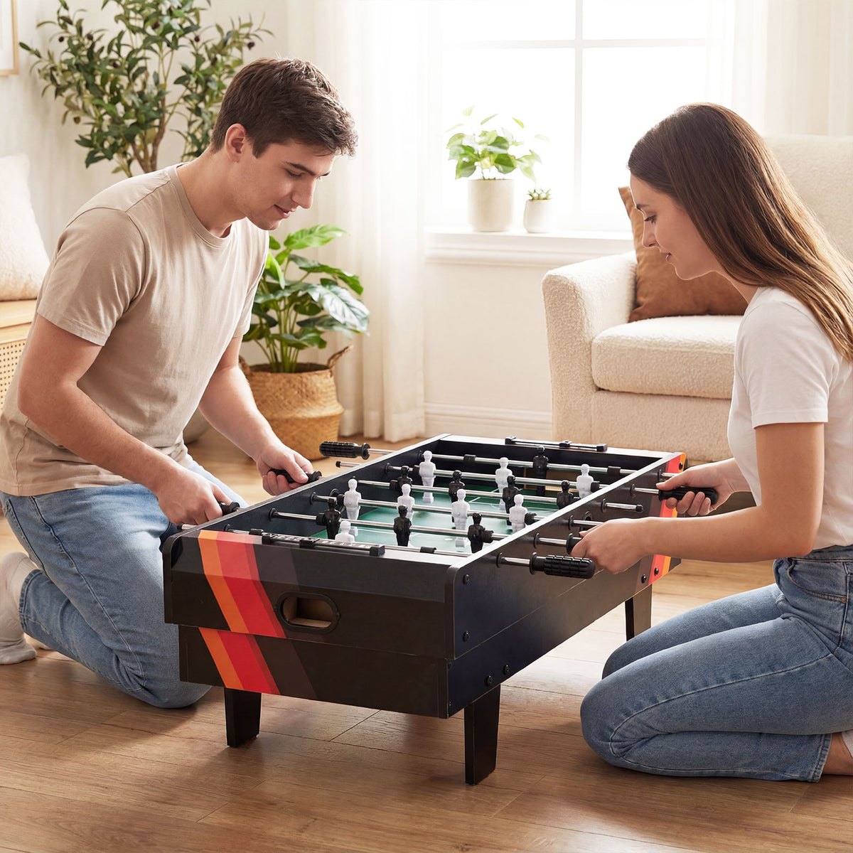 Two people playing foosball on the game table in a living room setting