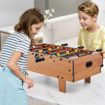 The game table set being used by two children for a foosball match on a white table