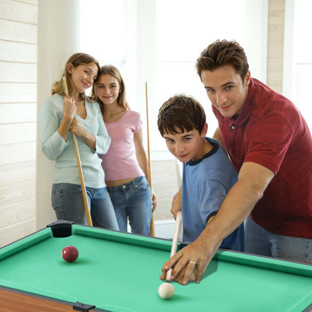 The game table set being used by a family for a game of billiards in a home setting