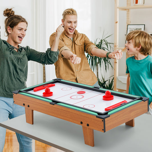 The game table set being used by a family for an air hockey match in a bright living room