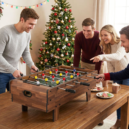 the game table placed on a dining table with people playing during Christmas