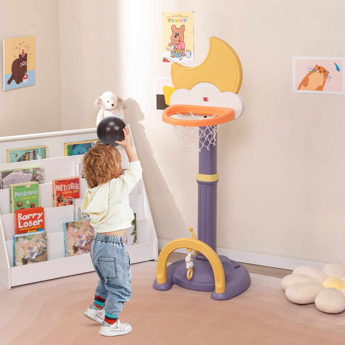 A child plays with the kids basketball hoop toy sports set indoors in a nursery