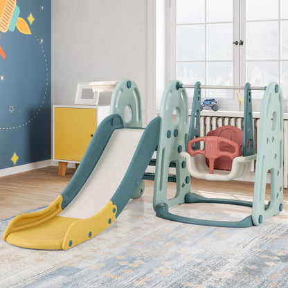 The green and blue kids slide and swing set set up in a room with toys