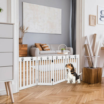 The white folding pet gate is set up in a living room, blocking a doorway, with a beagle puppy sitting in front of it